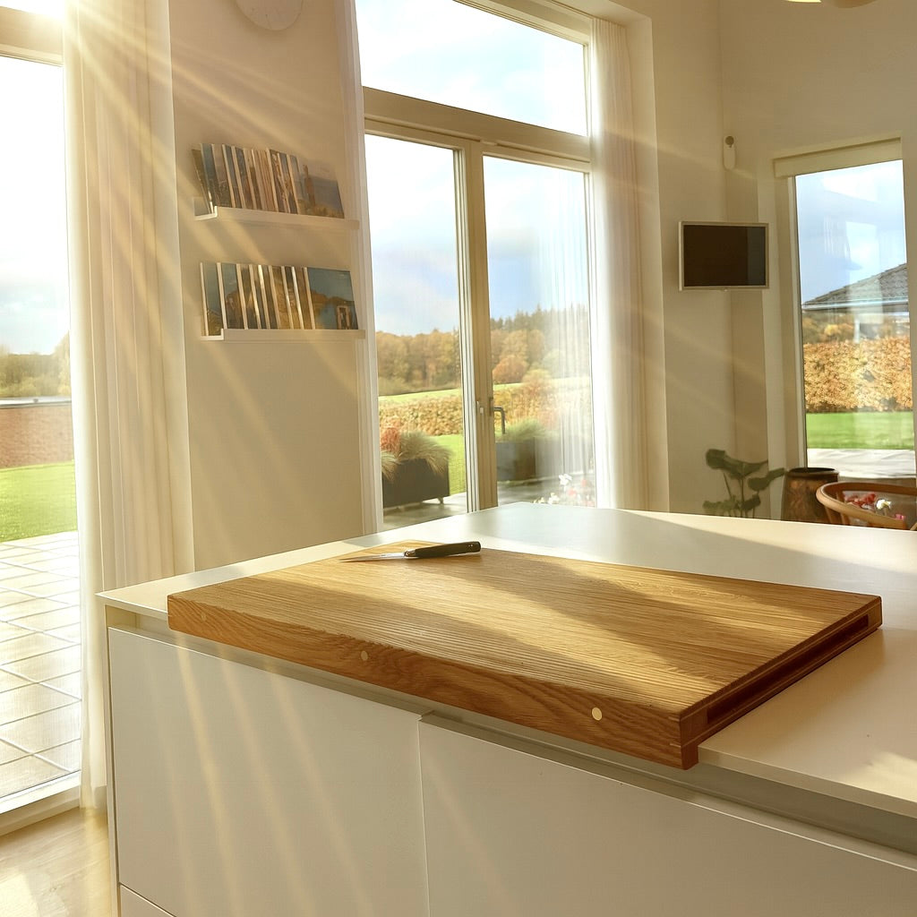 'Forefront' cutting board with a wooden leading edge and details in brass, copper or aluminum